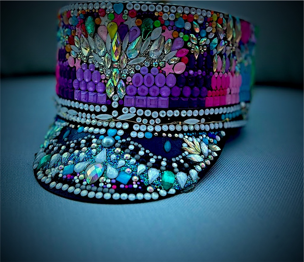 Crystal-encrusted captain cap in rainbow bands of magenta, violet and jade