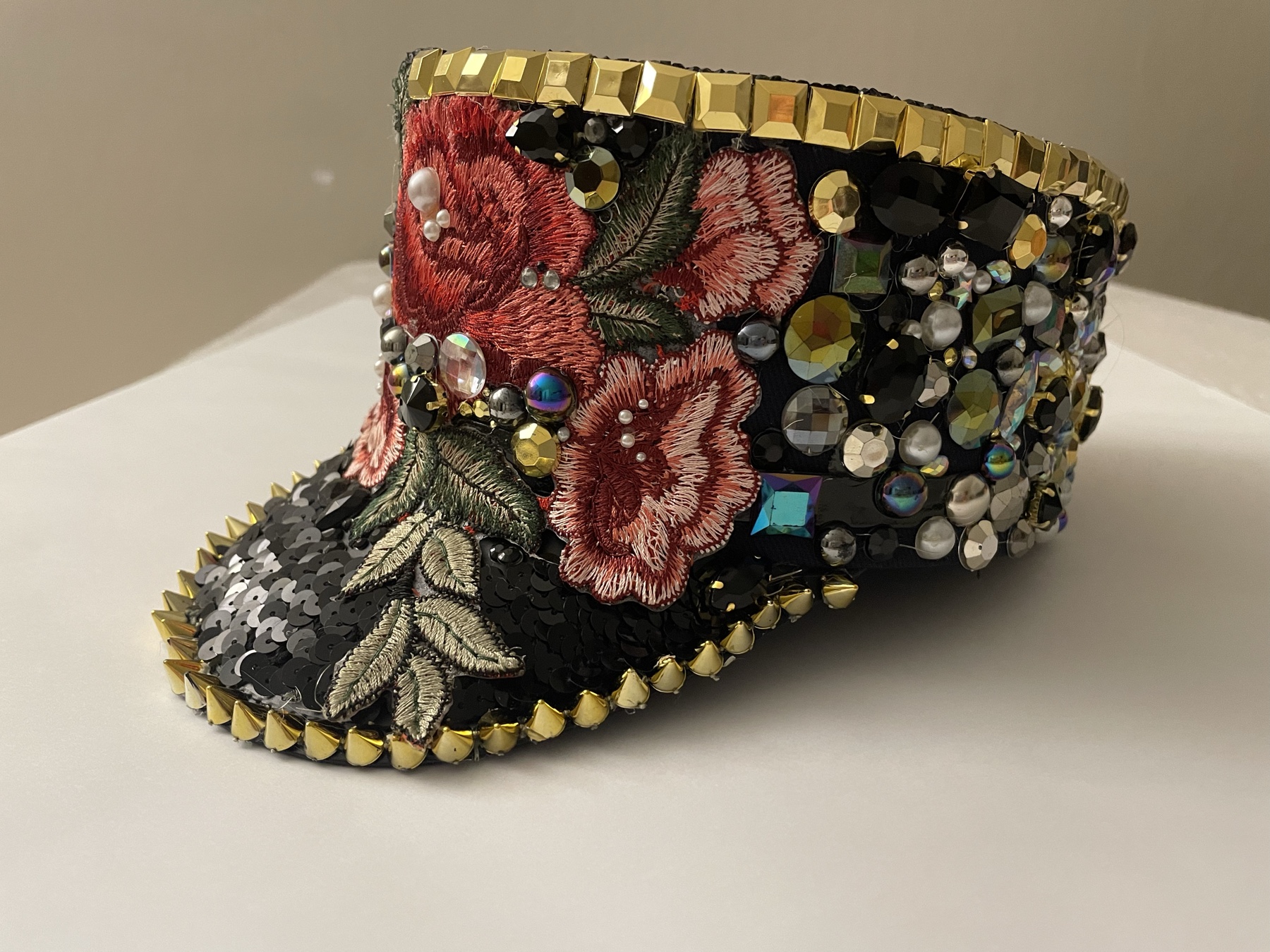 The Dreamer, a black velvet cap with embroidered roses, pearls and gold trim
