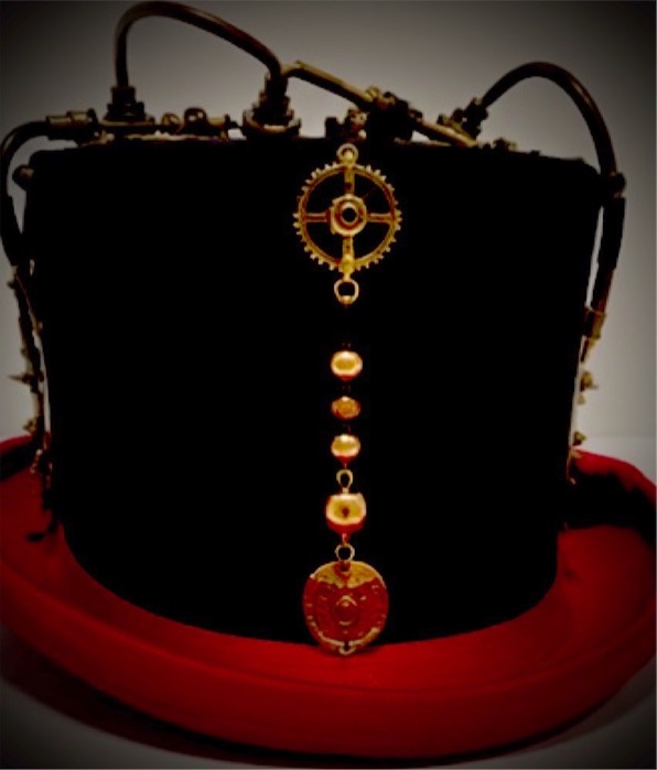 The Alchemist, brass gears on a scarlet-brimmed topper